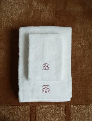 Folded spa towels embroidered with the monogram